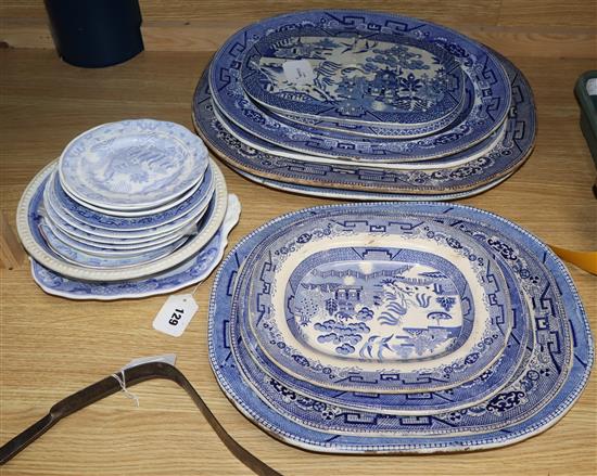 A quantity of blue and white transfer-printed Willow and Two Temples pattern tableware, including meat plates and drainers